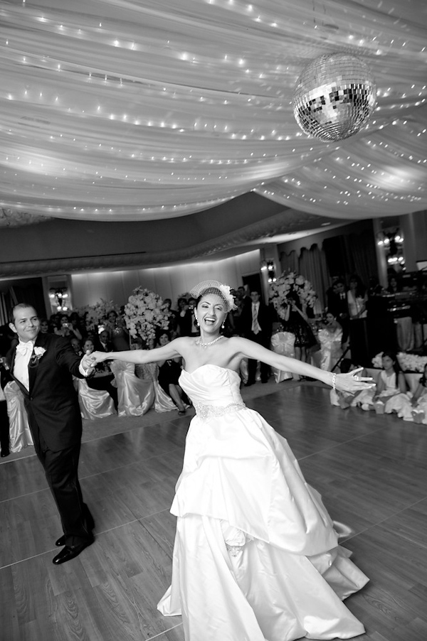 black and white photo of bride and groom dancing their first dance